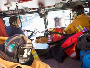 Fire men in fire truck during departure