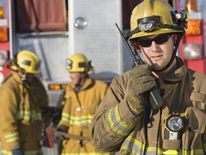 Firefighters talking on walkie talkies