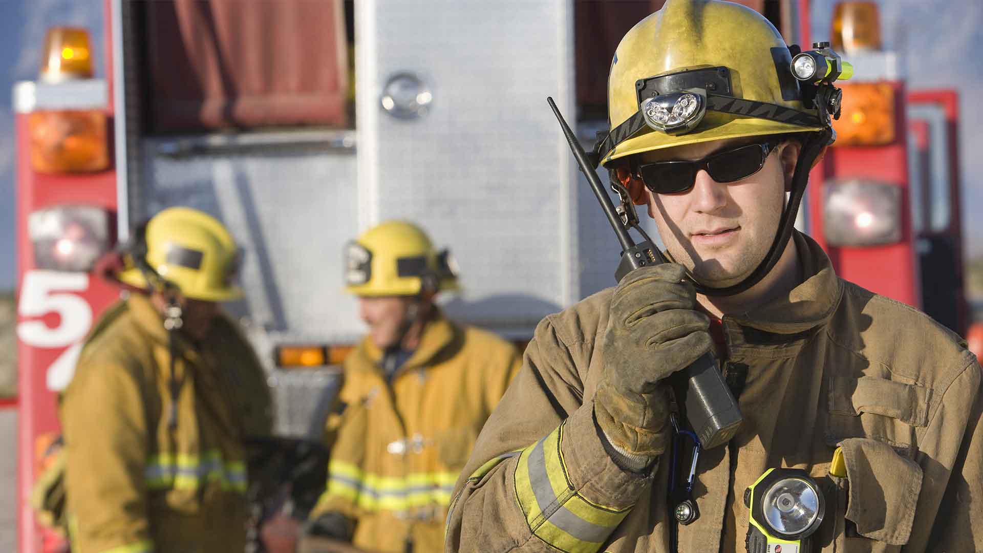 firemen talking on walkie talkies